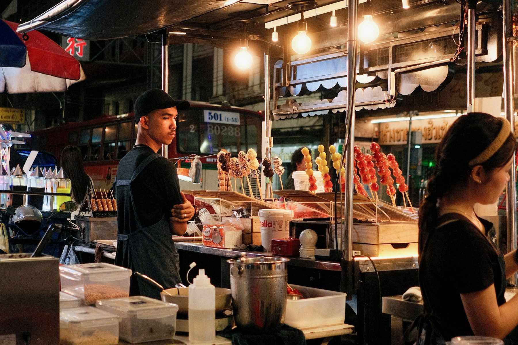 A brightly lit night-time street-food stall in Bangkok Chinatown on Yaowarat Road.