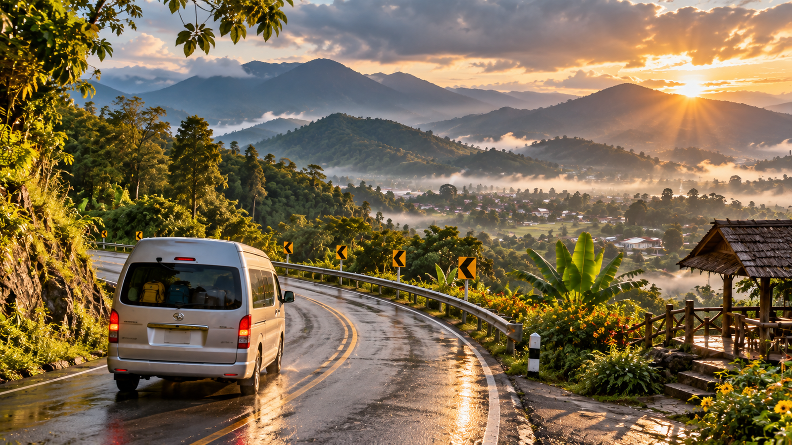 Minivan travelling along a wet winding mountain road above Pai valley at sunrise