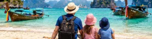 Original illustration of an adult and two children looking across a tropical Thai beach with limestone scenery.