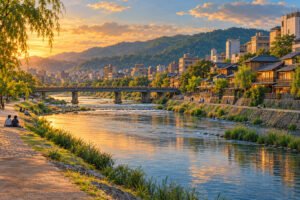 Illustration of a Kyoto-inspired river scene with riverside paths, a bridge, buildings and wooded hills in evening light.