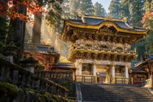Original editorial illustration inspired by Nikko’s ornate Yomeimon Gate, framed by tall cedar trees.