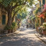 A leafy trading street with shopfronts, bicycles and pedestrians. AI-generated editorial illustration inspired by Hanoi’s Old Quarter; not a photograph of a particular street.