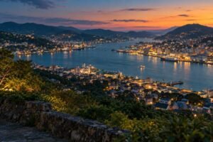 Nagasaki-inspired harbour at twilight, with city lights climbing the surrounding hills.